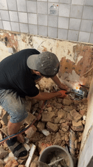 Torch cutting through pipes at a rubble-filled Roubaix site