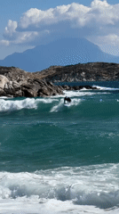Surfing a turquoise wave off the Greek coast at Toroni