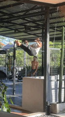 Man performs advanced calisthenics at outdoor gym in Mengwi