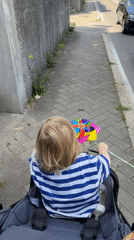 Child with pinwheel observed in stroller on Erba street