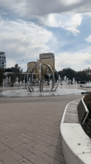 Astana public square: fountains and green walkways on a cloudy morning