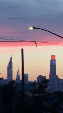 Shoes on a wire, pink sky over a New York dusk