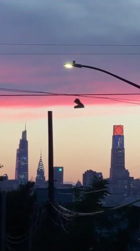 Shoes on a wire, pink sky over a New York dusk