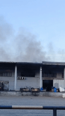 Industrial building emits dark smoke in Noviy, Russia