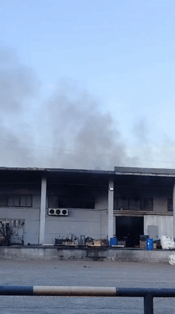 Industrial building emits dark smoke in Noviy, Russia