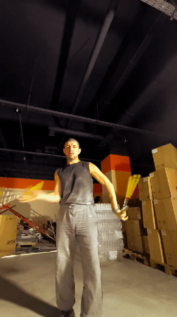 Juggling yellow props in a Qarağandı warehouse