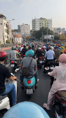 Heavy motorcycle traffic flows through Ho Chi Minh City streets