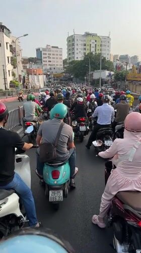 Heavy motorcycle traffic flows through Ho Chi Minh City streets