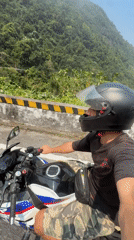 Motorcyclist spotted on winding road in Huế, Vietnam