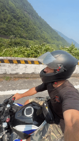 Motorcyclist spotted on winding road in Huế, Vietnam