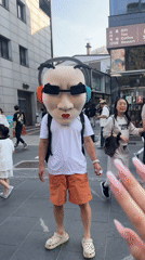 Masked street performer spotted in Seoul wearing distinctive costume