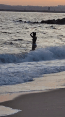 Sunset at the Quarteira shoreline, waves and warm light.