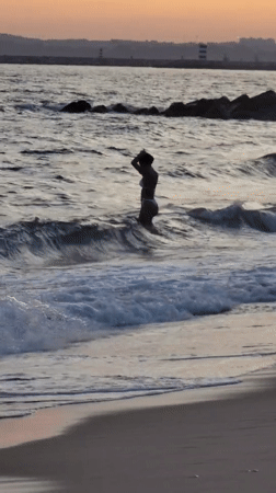 Sunset at the Quarteira shoreline, waves and warm light.