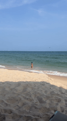 Sunny morning on the Mũi Né coast with wind sports and beach life