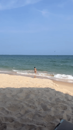 Sunny morning on the Mũi Né coast with wind sports and beach life