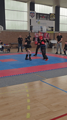Youth kickboxing match held in French gymnasium