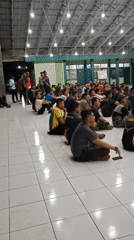 Indoor briefing or training session underway in Sukaraja gymnasium