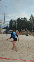 Beach volleyball at dusk, waterfront views nearby