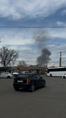 Dark smoke plume rises behind buildings in Yerevan