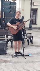 Street musician performs in busy Minsk district amid cafe scene