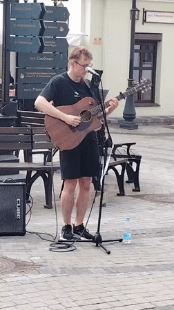 Street musician performs in busy Minsk district amid cafe scene