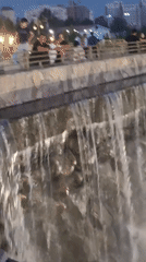 Urban park with fountains and monuments draws evening visitors
