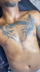 Man receives purple cross tattoo in Playa del Carmen