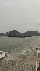 Morning ferry and barge traffic observed in Ha Long Bay