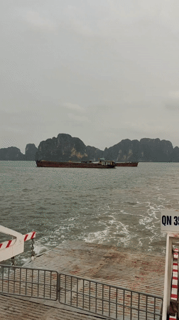 Morning ferry and barge traffic observed in Ha Long Bay