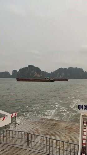 Morning ferry and barge traffic observed in Ha Long Bay
