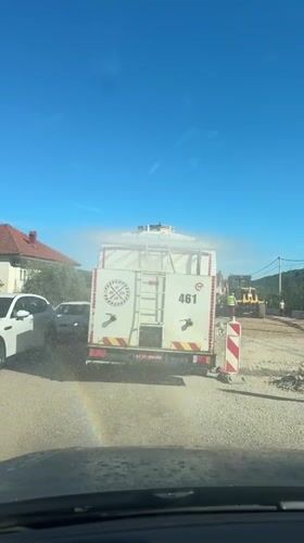 Water truck sprays dirt road in Montenegro village
