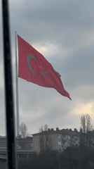 Turkish flag waves in early morning winds in Istanbul