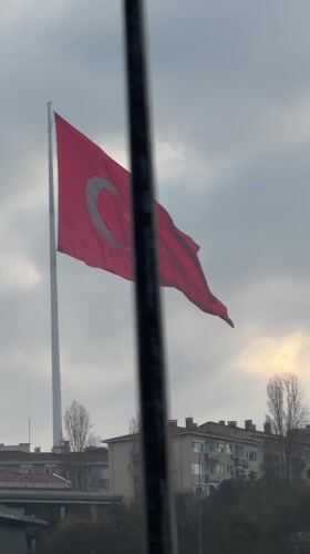 Turkish flag waves in early morning winds in Istanbul