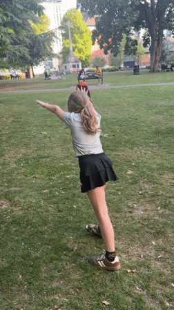 Girl plays with dogs in London park amid wildlife