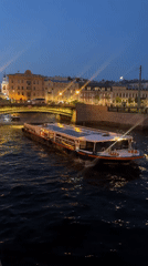 Woman enjoys evening canal walk amid Saint Petersburg's white nights