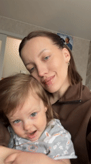 Woman documents morning routine with child in Reshetnikovo, Russia