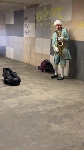 Costumed saxophonist performs in Riga tunnel amid local food displays