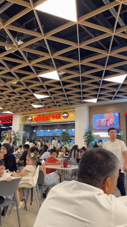 Inside a upscale Tashkent mall with a Ferrari on the floor