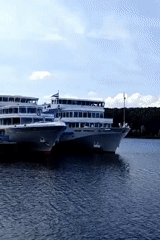 Two river cruise ships docked at Chaikovsky's sunny Kama embankment