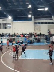 Women's basketball game played in Nairobi gymnasium evening hours