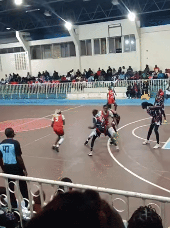 Women's basketball game played in Nairobi gymnasium evening hours