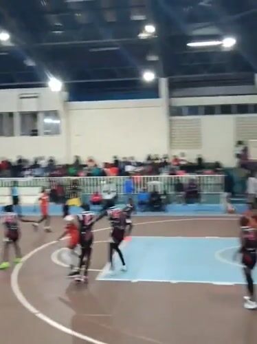 Women's basketball game played in Nairobi gymnasium evening hours