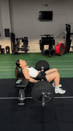 Woman performs barbell exercises at Mexican gym facility