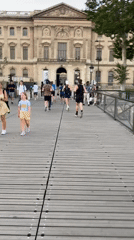 Runners cross wooden bridge near the Louvre, Paris