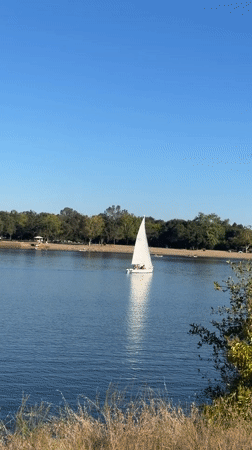 Sailboat cruising calm water on a sunny Fair Oaks afternoon