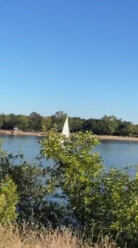 Sailboat cruising calm water on a sunny Fair Oaks afternoon