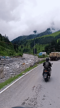 Scooter run through a misty Himachal valley on a grey morning