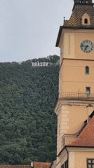 Tourist train and clock tower in Brașov's historic center