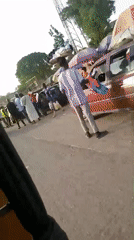 Damaged car being loaded with luggage on Nigerian road