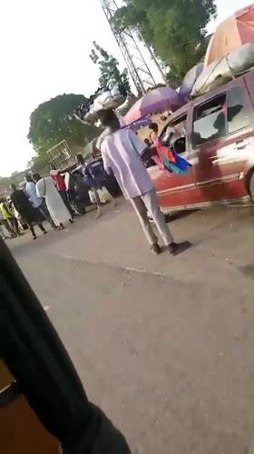 Damaged car being loaded with luggage on Nigerian road